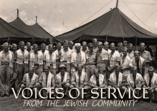 Group of Jewish men in traditional clothing posing in a camp with large tents in the background; caption reads 'Voices of Service from the Jewish Community'